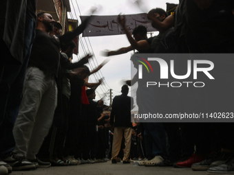 Shiite Muslim mourners are taking part in a Muharram procession on the fifth day of Ashura, in Srinagar, Jammu and Kashmir, on July 12, 2024...