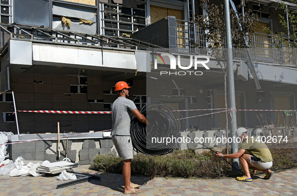 Workers are on the premises of the Ohmatdyt National Specialized Children's Hospital devastated by the Russian missile attack in Kyiv, Ukrai...