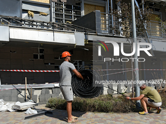 Workers are on the premises of the Ohmatdyt National Specialized Children's Hospital devastated by the Russian missile attack in Kyiv, Ukrai...