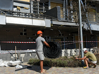 Workers are on the premises of the Ohmatdyt National Specialized Children's Hospital devastated by the Russian missile attack in Kyiv, Ukrai...