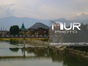 Residential houses are being seen on the banks of River Jhelum in Srinagar, Jammu and Kashmir, on July 12, 2024. (