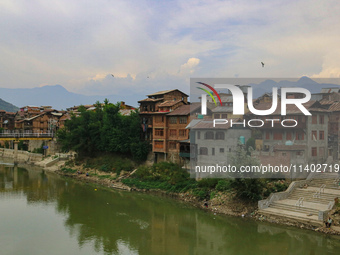 Residential houses are being seen on the banks of River Jhelum in Srinagar, Jammu and Kashmir, on July 12, 2024. (