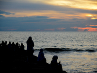 People are enjoying the sunset at Padang Beach in West Sumatra, Indonesia, on July 12, 2024. (