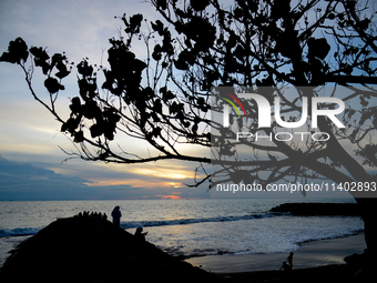 People are enjoying the sunset at Padang Beach in West Sumatra, Indonesia, on July 12, 2024. (