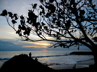 People are enjoying the sunset at Padang Beach in West Sumatra, Indonesia, on July 12, 2024. (