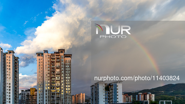 A photo is showing a rainbow over Nanchuan urban area in Chongqing, China, on July 12, 2024. 