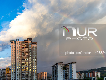 A photo is showing a rainbow over Nanchuan urban area in Chongqing, China, on July 12, 2024. (