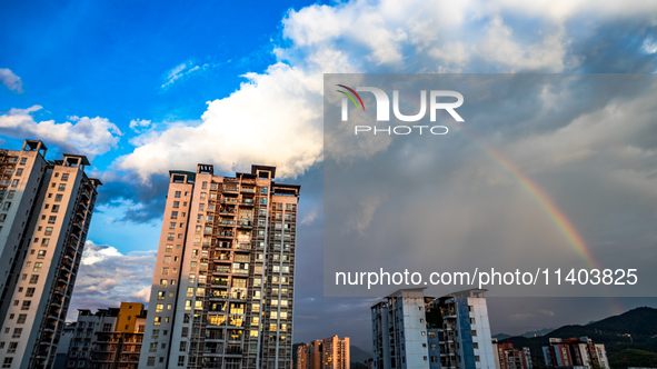 A photo is showing a rainbow over Nanchuan urban area in Chongqing, China, on July 12, 2024. 