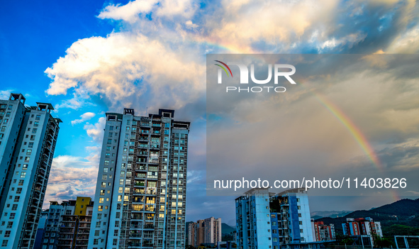 A photo is showing a rainbow over Nanchuan urban area in Chongqing, China, on July 12, 2024. 