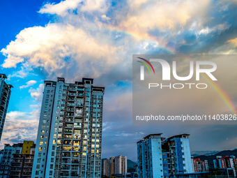 A photo is showing a rainbow over Nanchuan urban area in Chongqing, China, on July 12, 2024. (