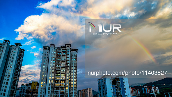 A photo is showing a rainbow over Nanchuan urban area in Chongqing, China, on July 12, 2024. 