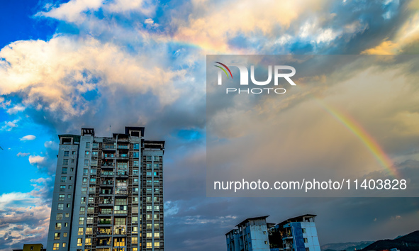 A photo is showing a rainbow over Nanchuan urban area in Chongqing, China, on July 12, 2024. 