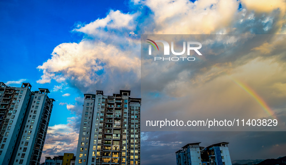 A photo is showing a rainbow over Nanchuan urban area in Chongqing, China, on July 12, 2024. 