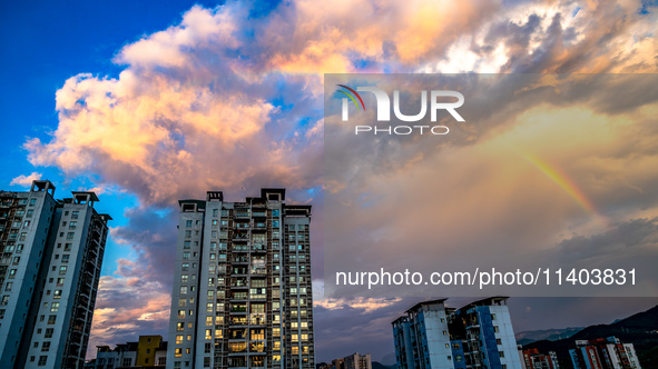 A photo is showing a rainbow over Nanchuan urban area in Chongqing, China, on July 12, 2024. 