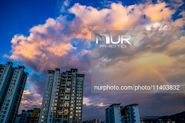 A photo is showing a rainbow over Nanchuan urban area in Chongqing, China, on July 12, 2024. 