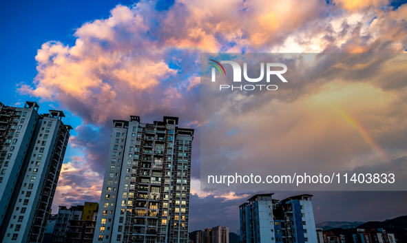 A photo is showing a rainbow over Nanchuan urban area in Chongqing, China, on July 12, 2024. 