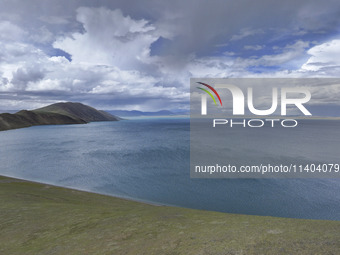 Tourists are enjoying the scenery of Bamucuo Lake in Nagqu, China, on July 12, 2024. (