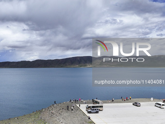 Tourists are enjoying the scenery of Bamucuo Lake in Nagqu, China, on July 12, 2024. (