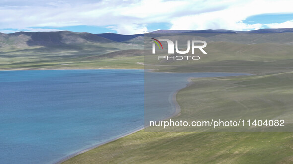 Tourists are enjoying the scenery of Bamucuo Lake in Nagqu, China, on July 12, 2024. 