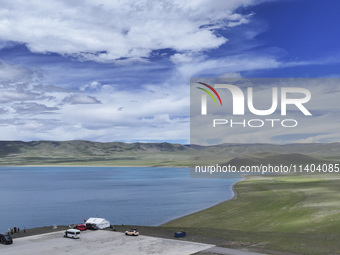 Tourists are enjoying the scenery of Bamucuo Lake in Nagqu, China, on July 12, 2024. (