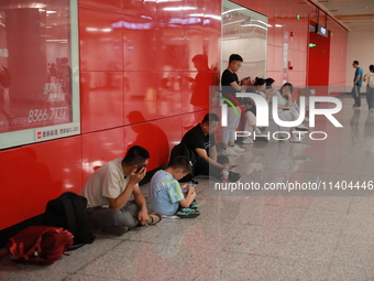 Citizens are cooling off at a subway station in Xi'an, China, on July 12, 2024. (