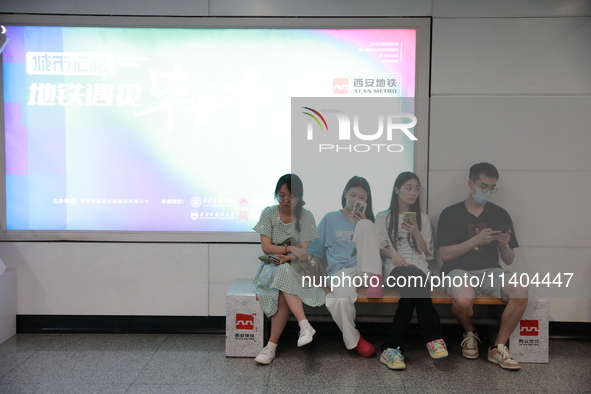 Citizens are cooling off at a subway station in Xi'an, China, on July 12, 2024. 