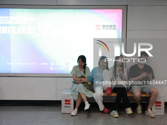 Citizens are cooling off at a subway station in Xi'an, China, on July 12, 2024. (