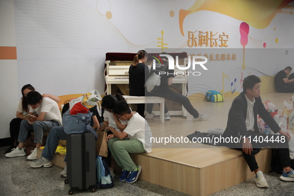 Citizens are cooling off at a subway station in Xi'an, China, on July 12, 2024. 