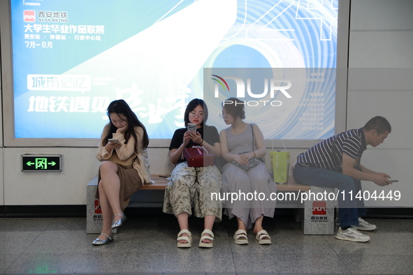 Citizens are cooling off at a subway station in Xi'an, China, on July 12, 2024. 