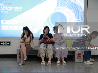 Citizens are cooling off at a subway station in Xi'an, China, on July 12, 2024. (