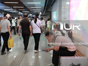 Citizens are cooling off at a subway station in Xi'an, China, on July 12, 2024. (