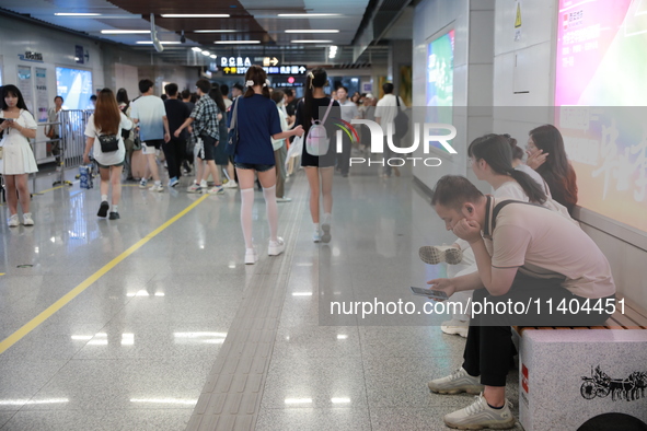 Citizens are cooling off at a subway station in Xi'an, China, on July 12, 2024. 