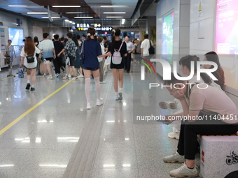 Citizens are cooling off at a subway station in Xi'an, China, on July 12, 2024. (