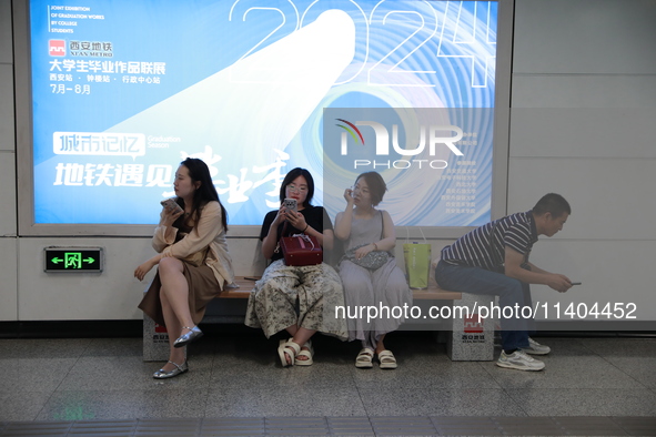 Citizens are cooling off at a subway station in Xi'an, China, on July 12, 2024. 