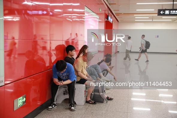 Citizens are cooling off at a subway station in Xi'an, China, on July 12, 2024. 