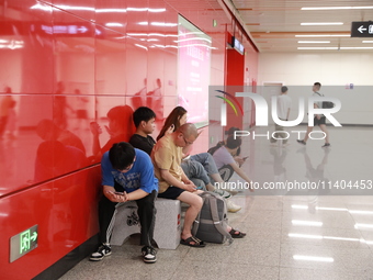 Citizens are cooling off at a subway station in Xi'an, China, on July 12, 2024. (