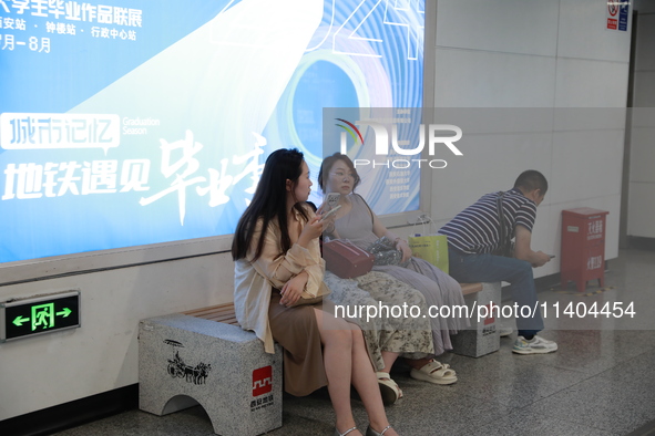 Citizens are cooling off at a subway station in Xi'an, China, on July 12, 2024. 