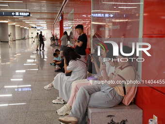 Citizens are cooling off at a subway station in Xi'an, China, on July 12, 2024. (