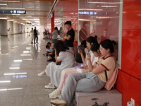 Citizens are cooling off at a subway station in Xi'an, China, on July 12, 2024. (