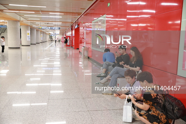 Citizens are cooling off at a subway station in Xi'an, China, on July 12, 2024. 