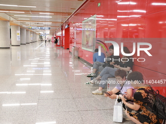 Citizens are cooling off at a subway station in Xi'an, China, on July 12, 2024. (