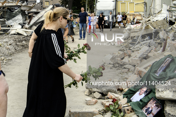 People are bringing flowers to the portraits of doctors and patients who died in Okhmatdyt Children's Hospital that was recently hit by a Ru...