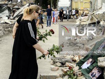 People are bringing flowers to the portraits of doctors and patients who died in Okhmatdyt Children's Hospital that was recently hit by a Ru...