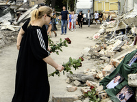 People are bringing flowers to the portraits of doctors and patients who died in Okhmatdyt Children's Hospital that was recently hit by a Ru...