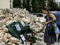 People are bringing flowers to the portraits of doctors and patients who died in Okhmatdyt Children's Hospital that was recently hit by a Ru...