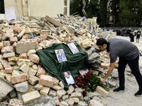 People are bringing flowers to the portraits of doctors and patients who died in Okhmatdyt Children's Hospital that was recently hit by a Ru...