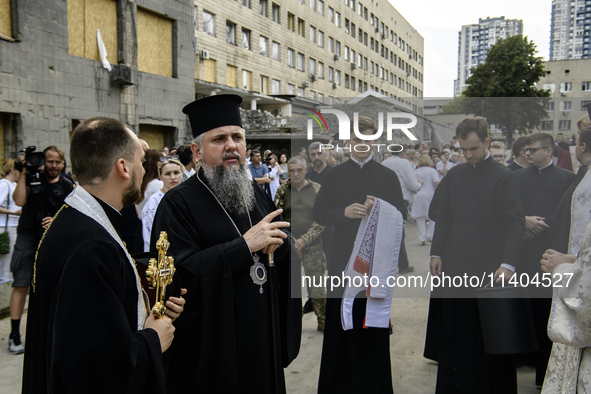 Metropolitan Epiphanius, the head of the Orthodox Church of Ukraine, is praying at the ruins of Okhmatdyt Children's Hospital that was recen...