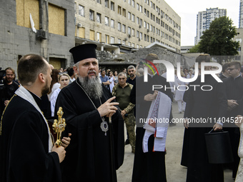 Metropolitan Epiphanius, the head of the Orthodox Church of Ukraine, is praying at the ruins of Okhmatdyt Children's Hospital that was recen...