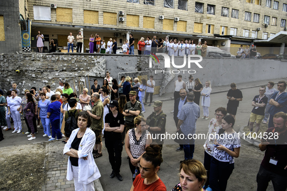 Medical workers are hearing as Conductor Herman Makarenko and the Kyiv Classic Orchestra are performing ''Requiem for the Dead'' at the ruin...