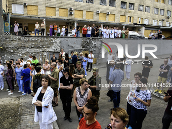 Medical workers are hearing as Conductor Herman Makarenko and the Kyiv Classic Orchestra are performing ''Requiem for the Dead'' at the ruin...